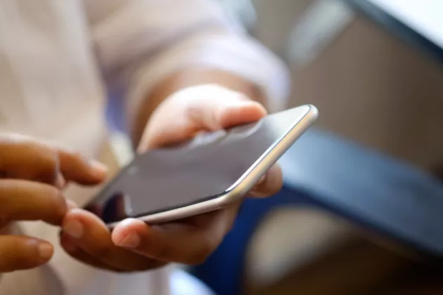 Close up of man using mobile smart phone.