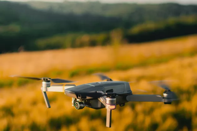 Drone over a field. Unsplash.